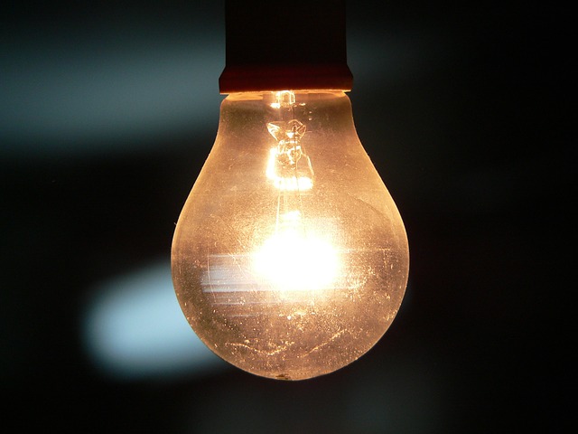 lit light bulb hanging from ceiling
