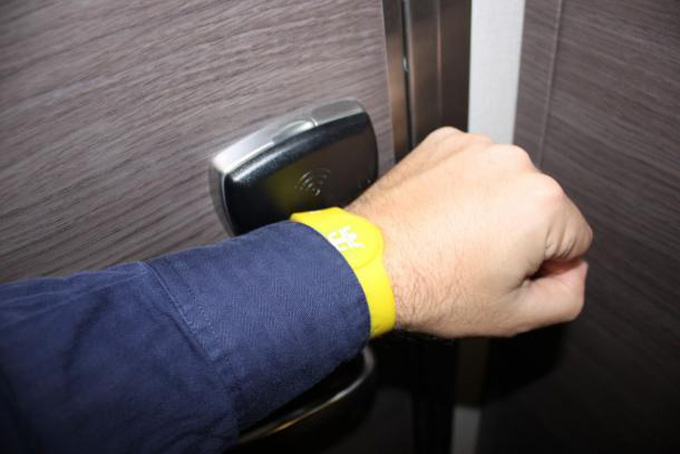 Royal Caribbean wristband being used to open a door
