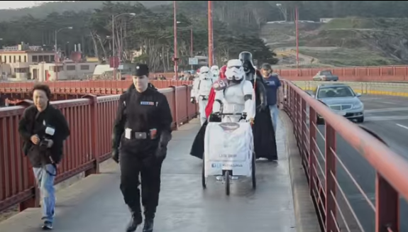 stormtrooper walking a baby over the golden gate bridge