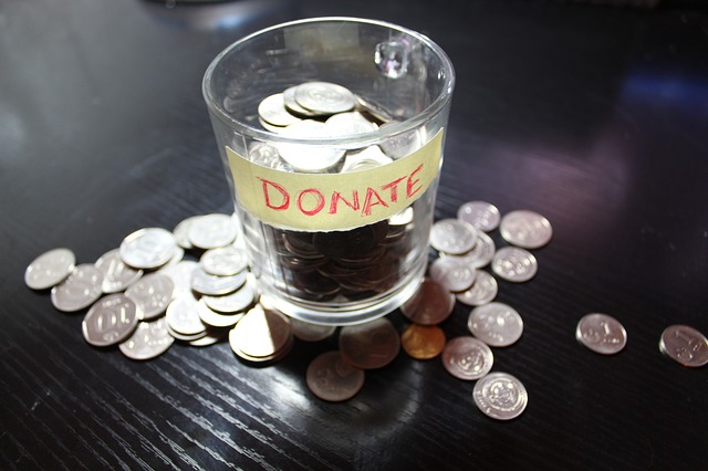 money tip cup overflowing with change and labeled donate