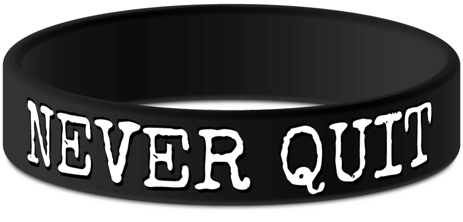 never quit rubber wristband in black with white text