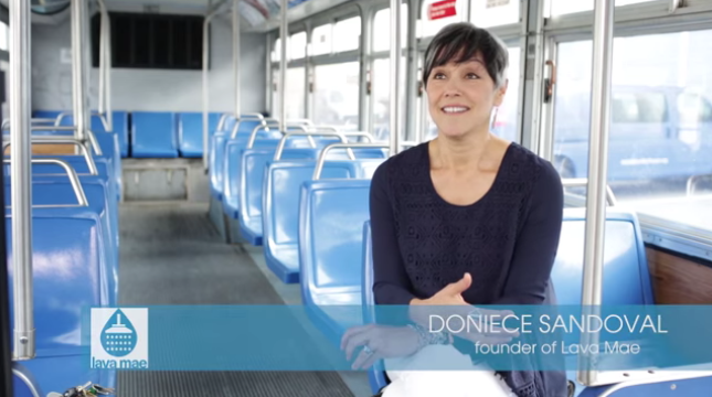 Doniece Sandoval discussing Lava Mae on a bus