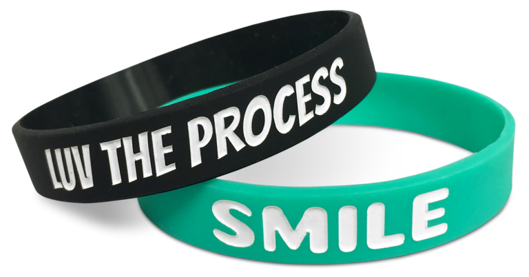 positive half inch wristbands saying smile and love the process