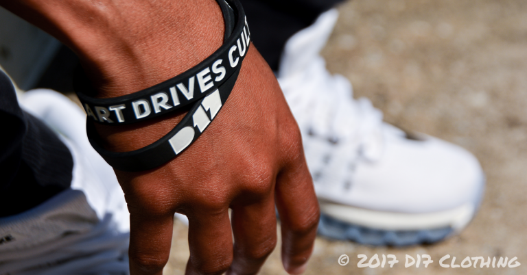 d17 clothing wristband in black with white text being worn on wrist