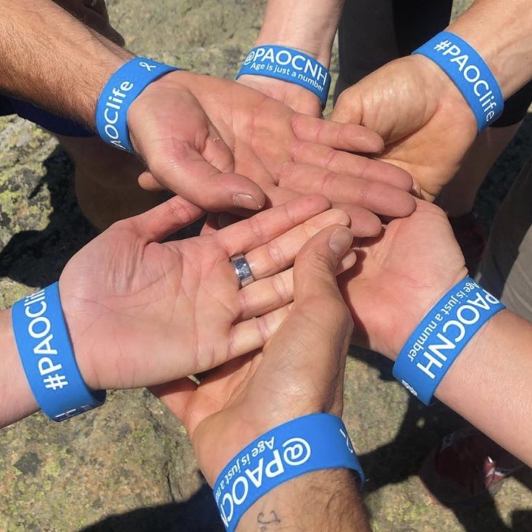 group of hands together wearing event wristbands
