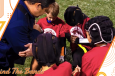 team takes a knee for prayer with the coach