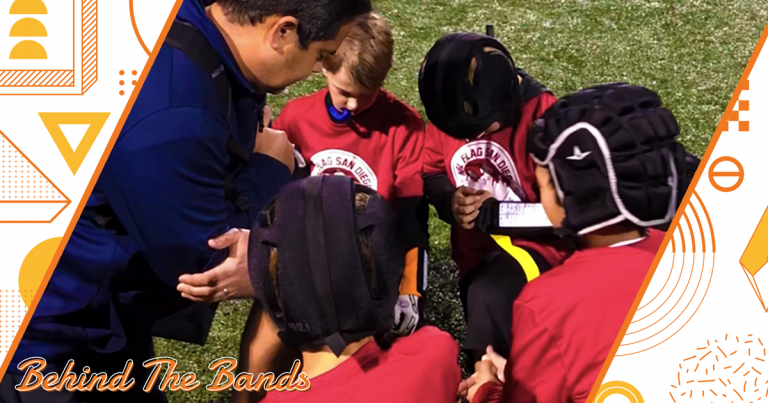 team takes a knee for prayer with the coach